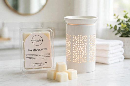 Lavender Lush Classic coconut soy wax melts clamshell beside a lit white ceramic wax warmer with loose wax cubes