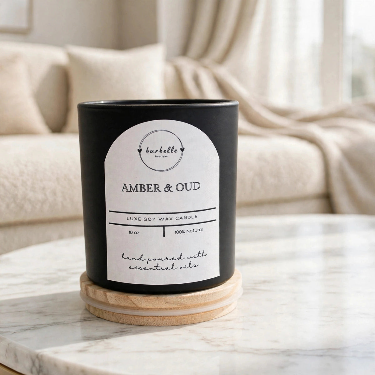 Amber & Oud luxe soy wax candle resting on its wooden lid, styled on marble in a bright living room. Clean non-toxic soy candle hand poured with essential oils, Burbelle Boutique.